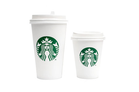 BERLIN - OCT 15: Two Starbucks Paper Cups long and short. Starbucks Coffee with Logo Mermaid isolated on white Background in Berlin on October 15. 2022 in Germanyのeditorial素材