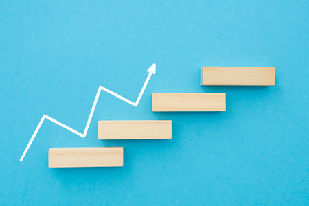 Imitation of wooden stairs and white pointer on blue background. Concept picture about progress, leadership and successesの写真素材