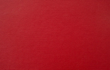 Blank red cardboard with cell pattern as background, bright red surface for holidays decorationの写真素材