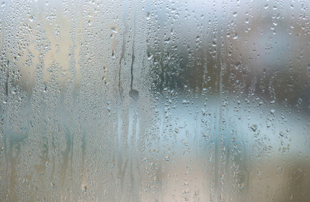 Window with condensation and raindrops after heavy rain, large texture or backgroundの写真素材