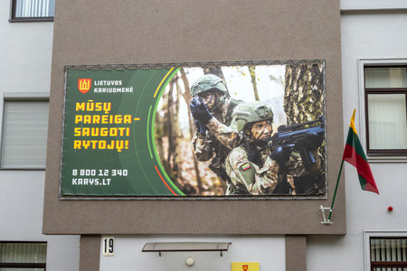 KAUNAS - JULY 09: Public service announcement or social advertisement about Lithuanian Armed Forces on facade of a building in Kaunas on July 09. 2022 in Lithuaniaのeditorial素材