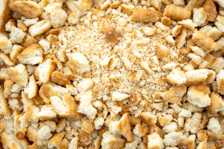 Close-up of a pile dried broken pieces of biscuit, heap of sweet bread crumbs, top viewの写真素材