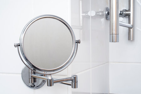Close-up of round mirror with steam on surface in bathroomの写真素材