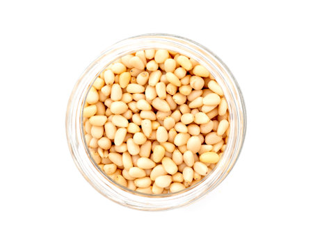 Prepared cedar pine nuts in round glass can isolated on white, top viewの写真素材