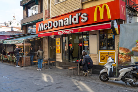 ISTANBUL - JAN 15: Facade of McDonald restaurant with visitors in a street in Istanbul on January 15. 2023 in Turkeyのeditorial素材