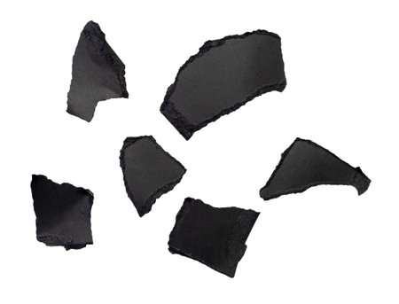 Abstract pieces of black torn paper, cardboard isolated on white, clipping pathの写真素材