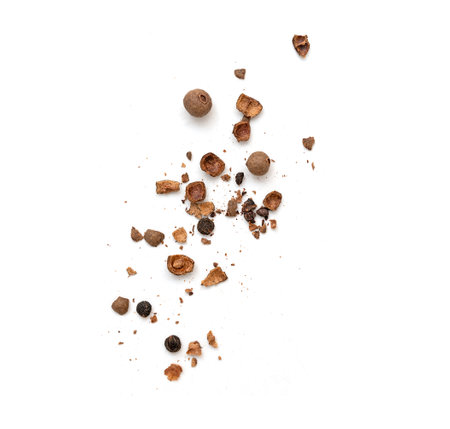Whole and broken all spice pieces falling and isolated on white, top viewの写真素材
