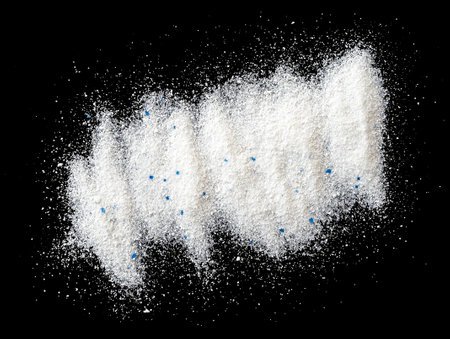 Pile of washing powder or laundry detergent isolated on black, top viewの写真素材