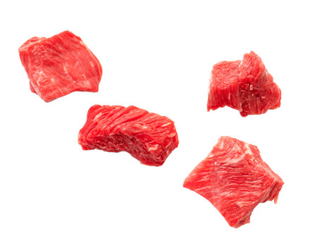 Pieces of raw beef meat falling and isolated on white. Slices of cutted red meatの写真素材
