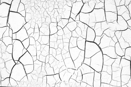 Old cracked dry paint on the wall as texture or backgroundの写真素材