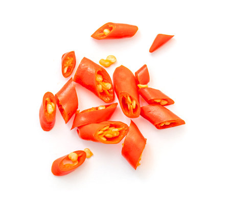 Heap of chopped Chili pepper with seeds isolated on white, top viewの写真素材