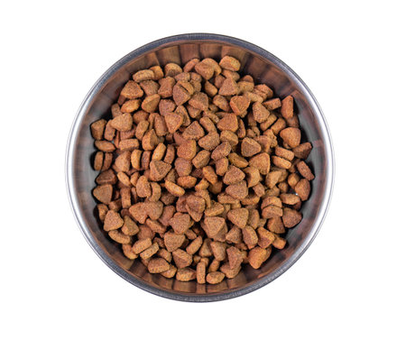 Steel bowl with dry crumbly pet feed isolated on white, top viewの写真素材