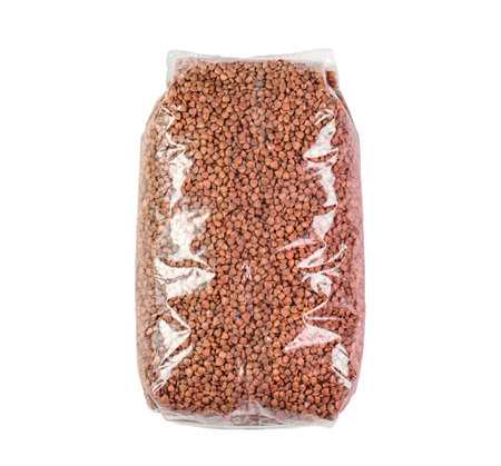 Transparent plastic bag with dried raw Buckwheat isolated on whiteの写真素材
