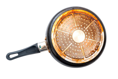 Bottom of an old used dirty frying pan isolated on white, top viewの写真素材