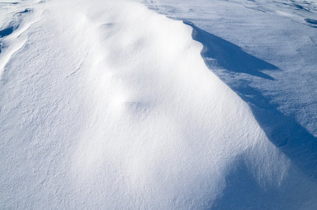 Sparkling snowdrift with icy surface in nature as texture or background, space for textの写真素材