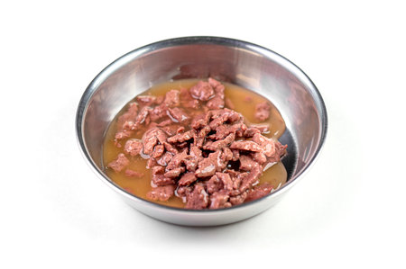 Steel bowl with wet pet feed, food isolated on white, top viewの写真素材