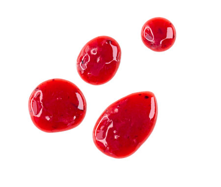 Four round drops of red berry sauce or jam isolated on white backgroundの写真素材
