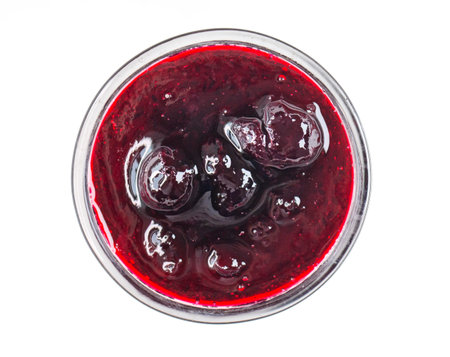 Glass bowl with black currant jam, sweet sauce isolated on white, top viewの写真素材