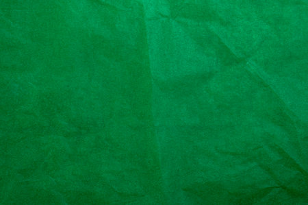 Crumpled dark green tracing paper as texture, holiday backdrop or background, square pictureの写真素材