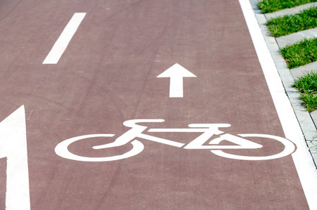 Designation of bicycle and arrow on the road, pedestrian path in a cityの写真素材