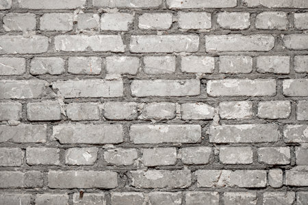 Close-up of flat brick wall with rows of cement concrete bricks as backgroundの写真素材