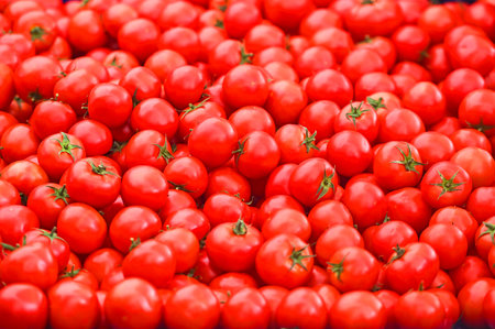 Heap of fresh red tomatoes at a street marketの写真素材