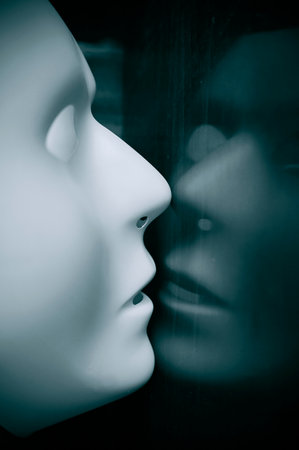 Old vintage mirror and reflection of white mask, concept picture about mental healthの写真素材