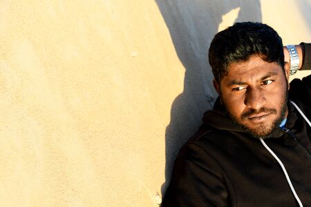 Indian man in the desert dunes posing for portrait photo at close upの写真素材