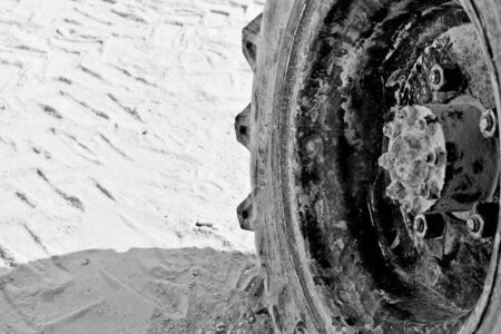 Old tire, worn and dirty in the ground