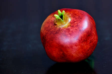 pomegranate, close up shot in red color on a table for use in webの写真素材