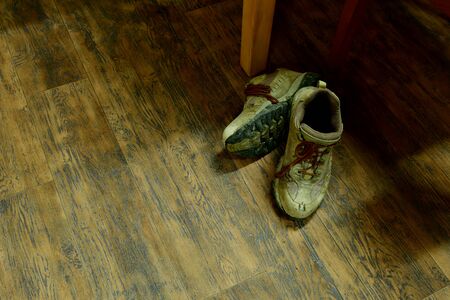 used work shoes on the wooden floor HARDWOODの写真素材