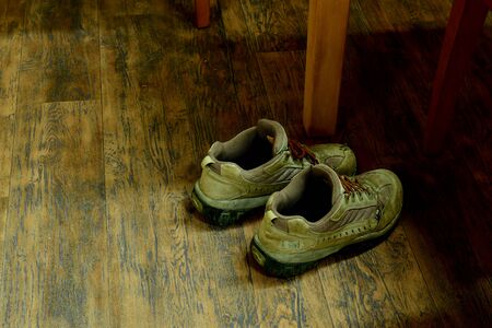 used work shoes on the wooden floor