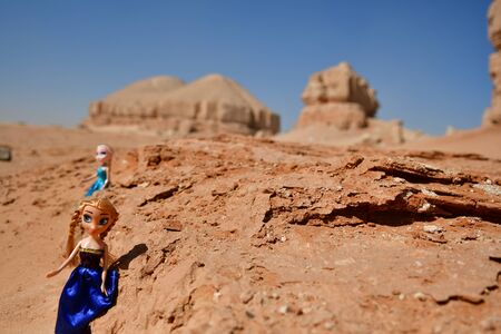 blonde dolls in the desert surroundings