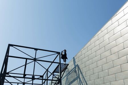 girl with the bag on the roof of the buildingの写真素材
