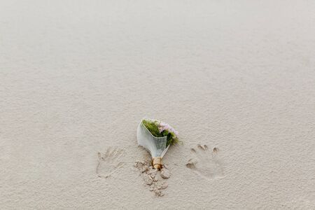 wedding bouquet on the sandの写真素材