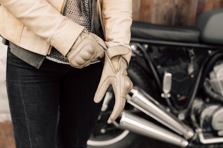 Motorcycle kaferacers. Girl dress leather gloves. Beige leather gloves. Gloves for motorcycle riding.の写真素材