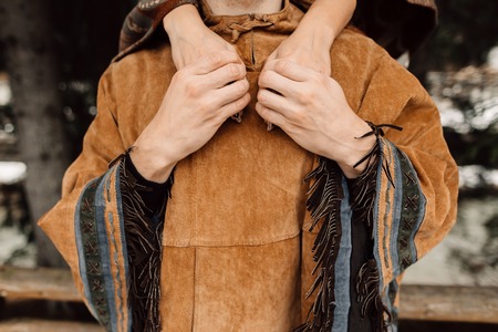 The hands of men and women. A man in a poncho. Ponchoの写真素材