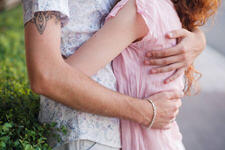 Happy couple walking on a street and hugging  の写真素材