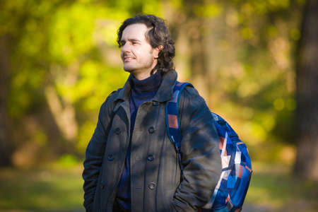 Man walking outdoors in an autumn park.の写真素材