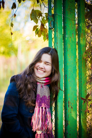 Cute girl smiling and walking in autumn park.の写真素材