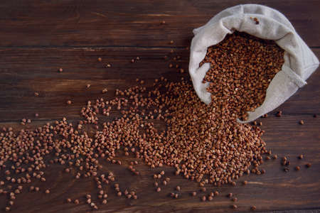 buckwheat is in a linen bag that stands on a wooden tableの写真素材