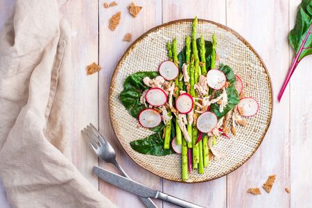 Asparagus salad with chicken, radish, beet leafs and rye crumbの写真素材