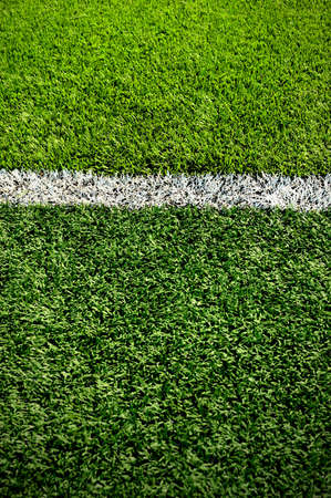 White stripe on the green soccer field from top view
