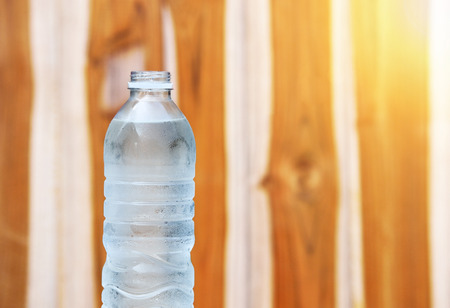 A bottle of Drinking water on wooden backgroundの写真素材