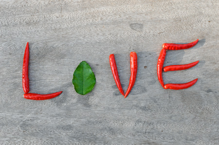 Chili pepper love on a wooden backgroundの写真素材