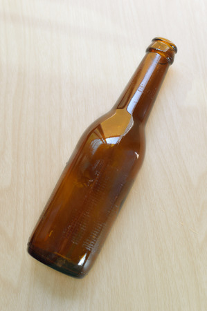 Old beer bottle on wood backgroundの写真素材