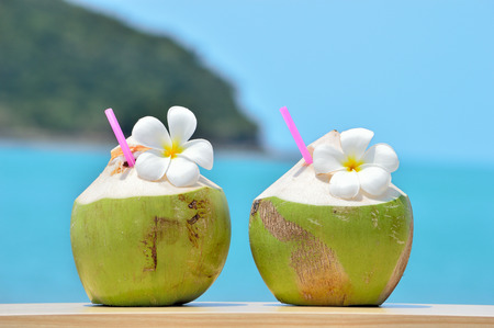 Tropical fresh coconut cocktail decorated plumeria on tropical caribbeanの写真素材