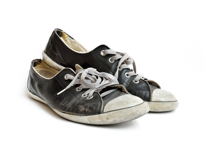 Old & dirty shoes isolated on white backgroundの写真素材