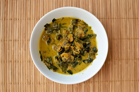 Thailand spicy cockle curry with wood backgroundの写真素材