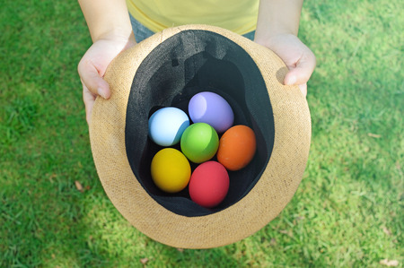 Colorful Easter eggs on a spring summer hat